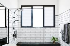 11 a stylish black and white bathroom done with white subway tiles and black hexagon ones