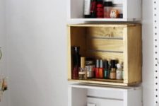 11 a trio of crate shelves on the wall in different colors to organize small stuff in your bathroom