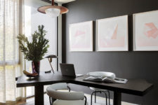 12 The home office nook is moody and is refreshed with pink artworks