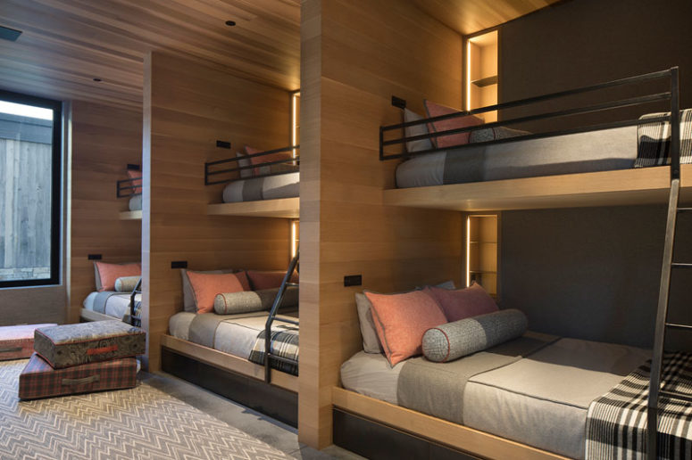 This is a multiple guest bedroom with lots of bunk beds and built-in lights