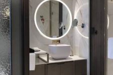 12 a minimalist bathroom with built-in lights in the mirror and wall around the vanity looks super chic and amazing
