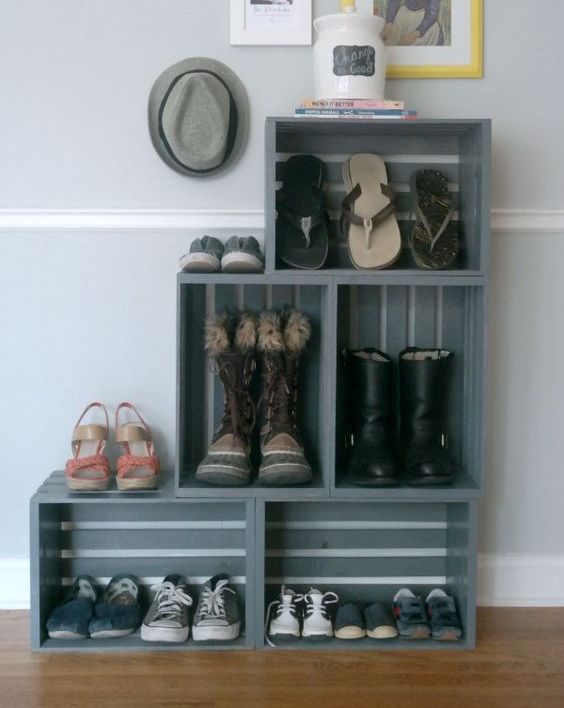a turquoise bookshelf fully made of crates placed on vintage legs is a stylish rustic furniture piece