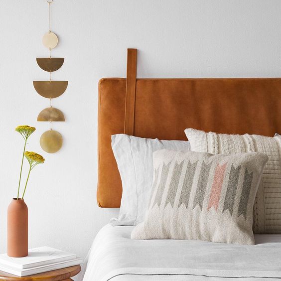 an amber hanging leather headboard is a trendy modern idea that can be easily added to any bed