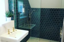12 navy hexagon tiles accented with white grout are paired with large scale neutral tiles