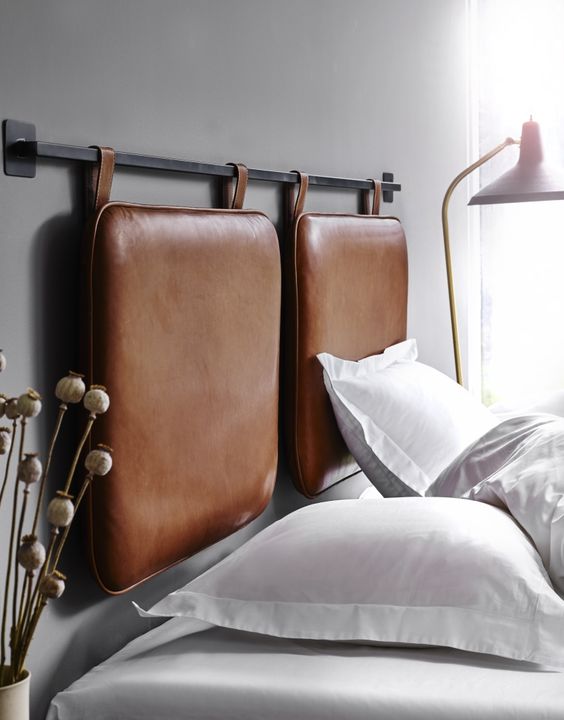 a hanging leather duo hheadboard in brown is a stylish way to accentuate a contemporary or minimalist bedroom