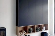 13 a large navy storage wall-mounted unit built of several IKEA Metod cabinets and some open storage boxes underneath