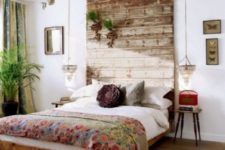 13 a weathered wood headboard that is extended to the ceiling to have a bigger impact