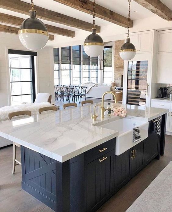 a chic farmhouse kitchen with elegant pendant two tone lamps on chains that highlight the mood and style