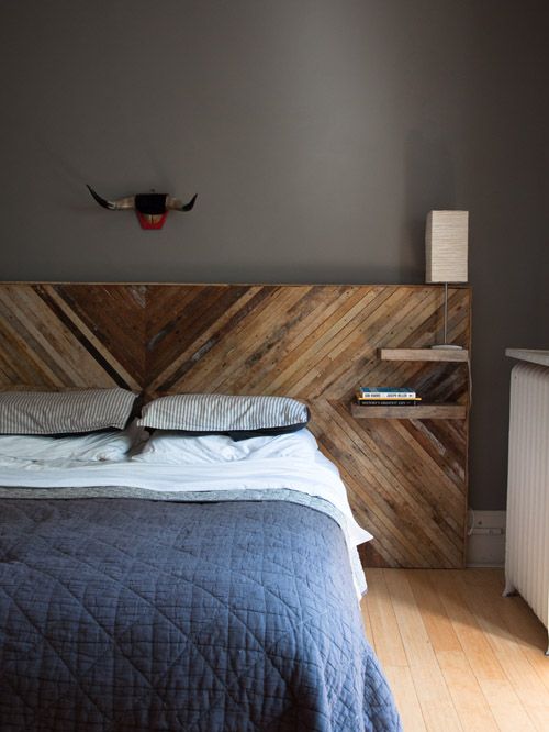 a chic reclaimed wood headboard with a herringbone pattern and tiny floating nightstand shelves for a touch of texture