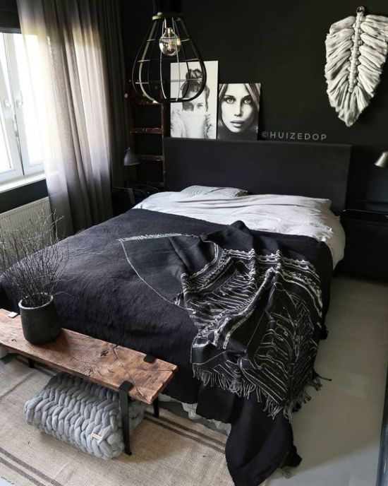 a Nordic bedroom with black walls, a chic bedding set, artworks and white touches