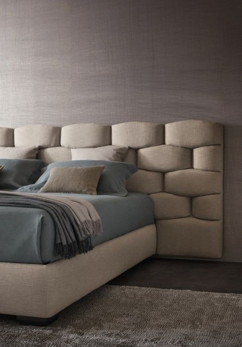 A creative textural padded headboard that takes some space around looks ultra modern and bold