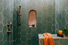 16 green hex tiles with copper grout make up a chic and bold bathroom space