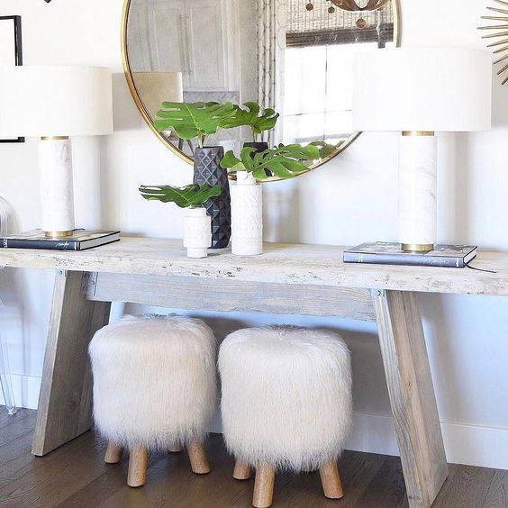 two little stools covered with white faux fur will add a chic and cozy touch to the space