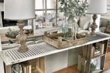 17 a farmhouse console table made of wooden crates and a shutter looks very rustic and relaxed