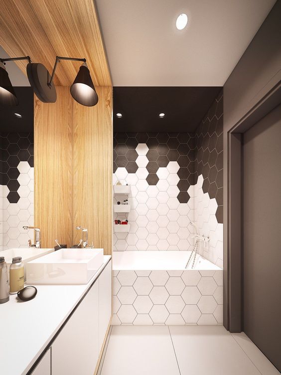 chic black and white hex tiles with conttrasting grout make up a chic geometric bathroom