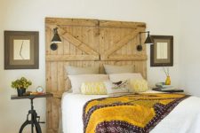 18 a barn door used as a headboard in this bright bedroom features lamps and add a cozy rustic touch