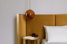 18 a curved mustard velvet headboard in a gold frame is a stylish and chic option for any sleeping space