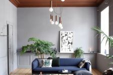 18 a statement modern chandelier featuring multiple bulbs with copper touches