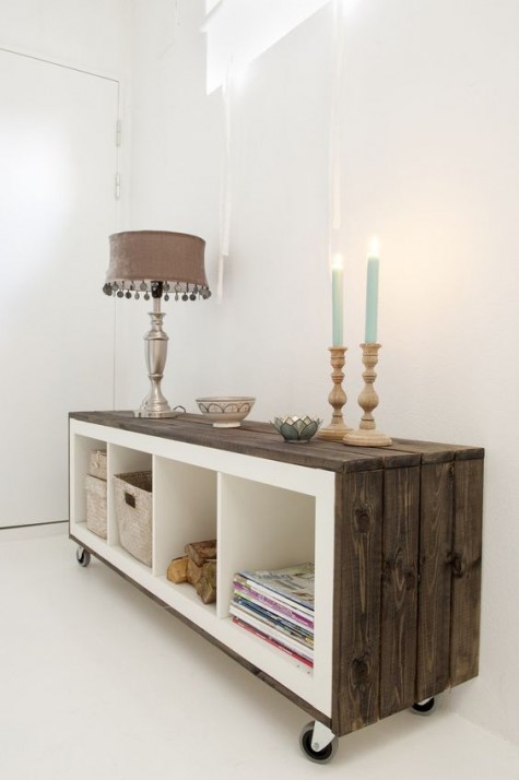an IKEA Expedit shelf covered with weathered wood and put on casters looks super cool