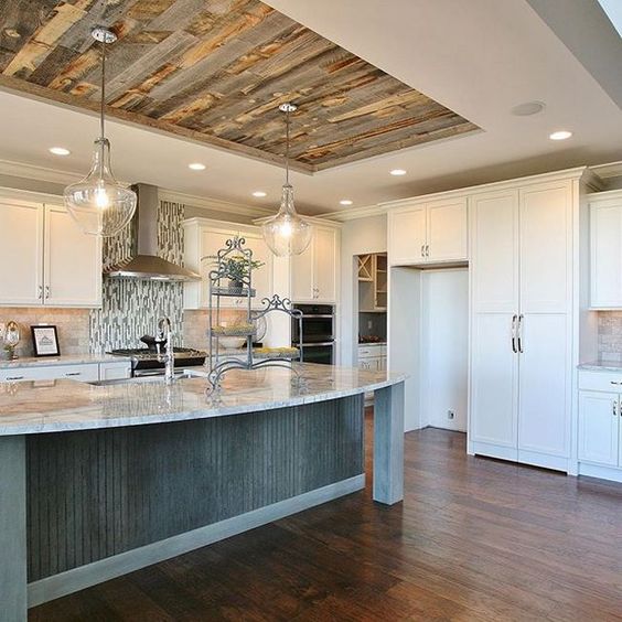 ceiling lights combined with elegant chandeliers over the kitchen island to get enough light