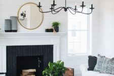 19 a black chanddelier imitating old candle ones contrasts the neutral space and adds drama