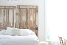 20 a light-filled and airy bedroom with a crystal chandelier, shabby chic doors looks very refined and elegant