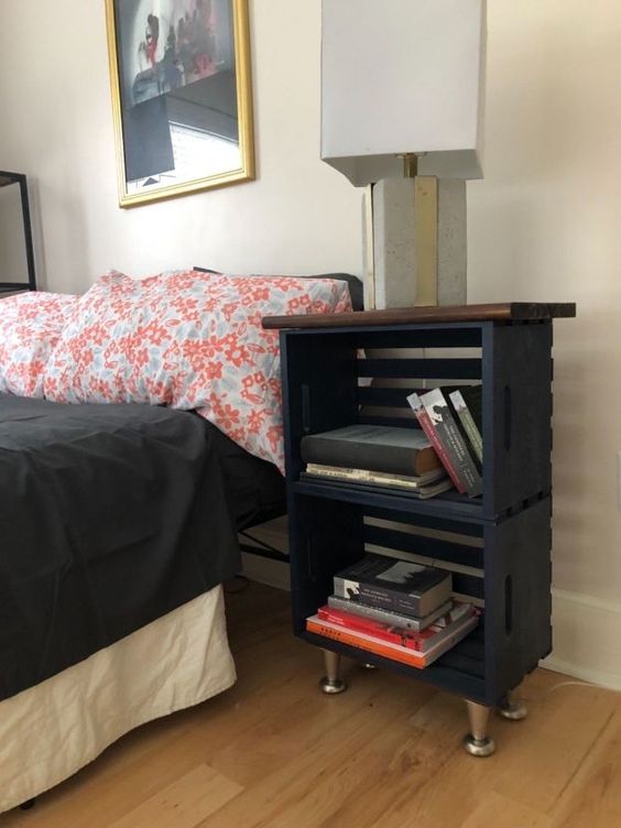 a modern farmhouse nightstand of black crates, a stained tabletop and metal legs is a chic idea