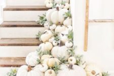 20 a staircase decorated with white pumpkins, gourds and pale greenery to make it fall-like