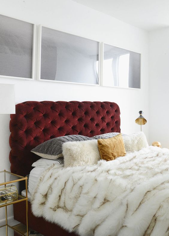 a tufted headboard upholstered in a deliciously deep red velvet is the ultimate luxury
