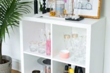 23 a stylish home bar made of an IKEA Kallax shelf with elegant gilded legs will easily fit many rooms