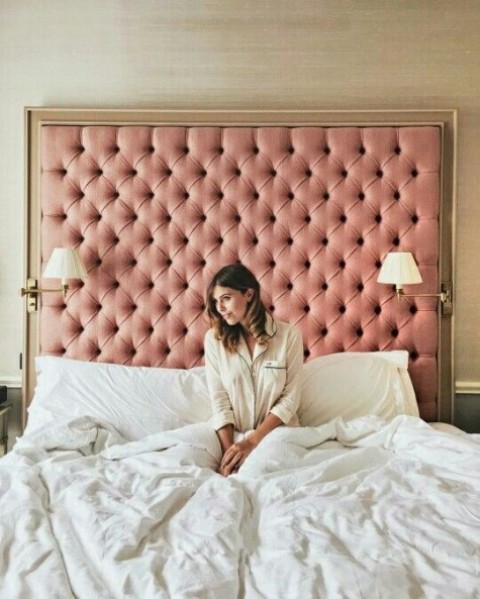 an oversized pink framed headboard will become an elegant statement decoration, and lamps attached to it will add functionality