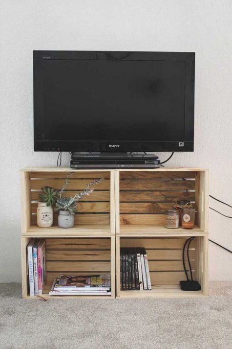 a TV unit made of crates is a simple and stylish idea with plenty of storage that can be made very fast and easily