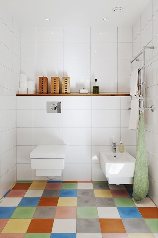 a bathroom spruced up with colorful tiles on the floor to make it catchier and cooler