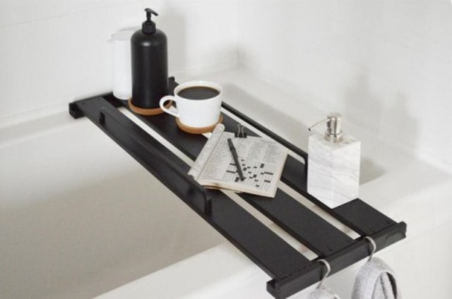 an Ikea Hejne bookcase shelf transformed into a stylish bathtub tray and stained dark