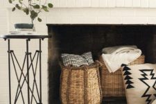25 style your non-working fireplace with baskets with blankets and throws and a faux fur rug
