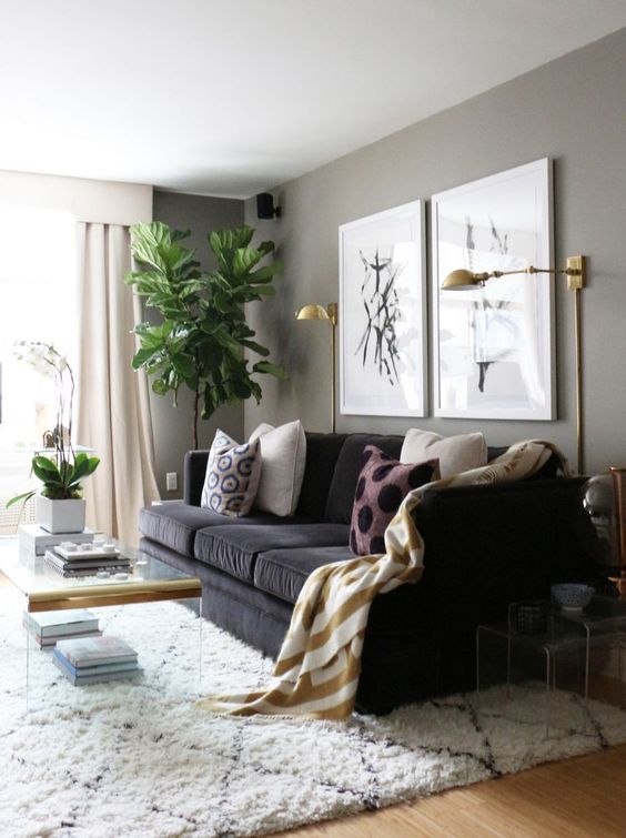 some brass wall sconces add a glam feel to the living room and provide some light, too