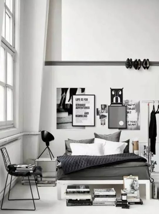 A Scandinavian bedroom with industrial touches   a metal shoes holder on the wall, a makeshift closet and some blackened metal touches