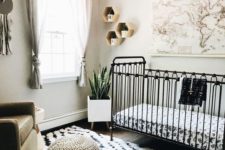 a black and white nursery with a printed rug, hexagon shelves and a map plus a neutral chair and footrest