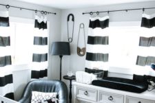 a stylish nursery with a vintage dresser, striped curtains, printed bedding and a faux fur rug