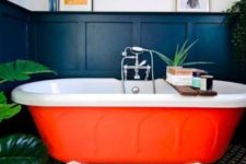 02 a bright orange bathtub with claw feet is a cool fall-inspired idea for a bathroom and will raise the spirits
