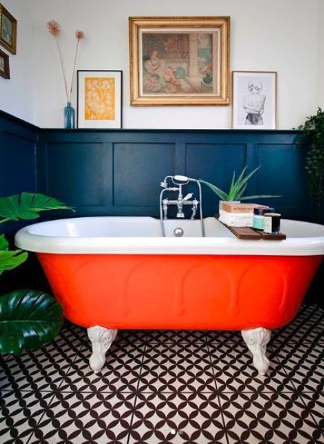a bright orange bathtub with claw feet is a cool fall-inspired idea for a bathroom and will raise the spirits