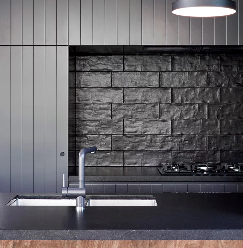The kitchen will remind you of Japanese minimalism and the textural tiles on the backsplash give interest to it
