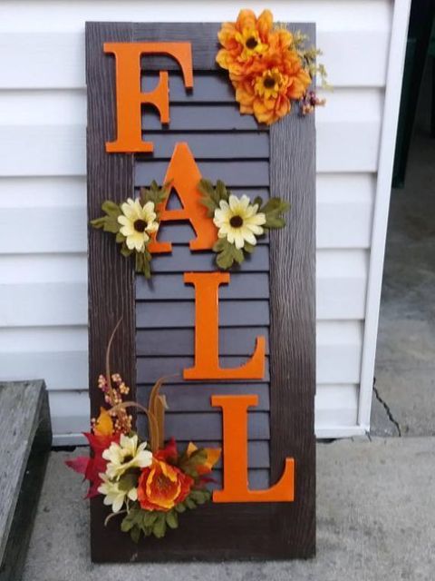 An old shutter repurposed into a cool and bright fall sign, a creative and budget friendly idea