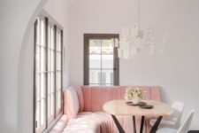 06 The breakfast zone shows off a pink upholstered corner sofa and some white chairs