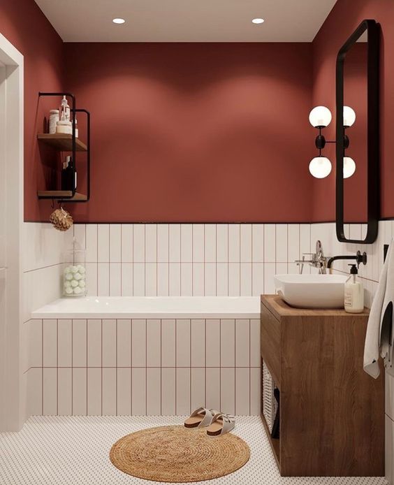 a burgundy wall paired with neutral tiles with matching grout is a cool fall-like idea