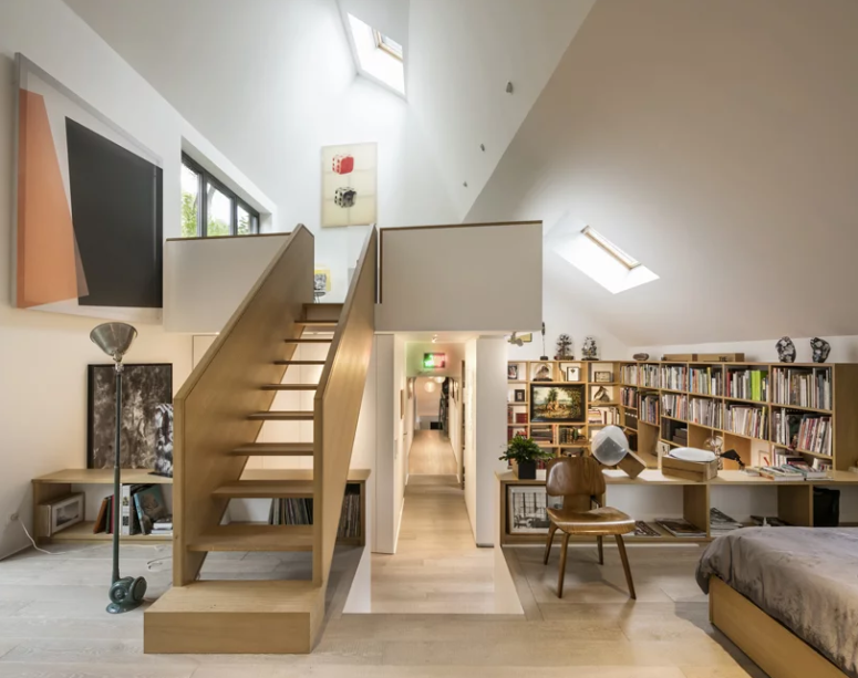 The extension is done in a neutral color palette, with uch light-colored wood and plywood
