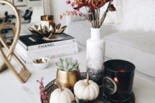 07 a stylish fall arrangement of a tray with blakc and white embellished pumpkins, a black candleholder and dried blooms in an ombre vase