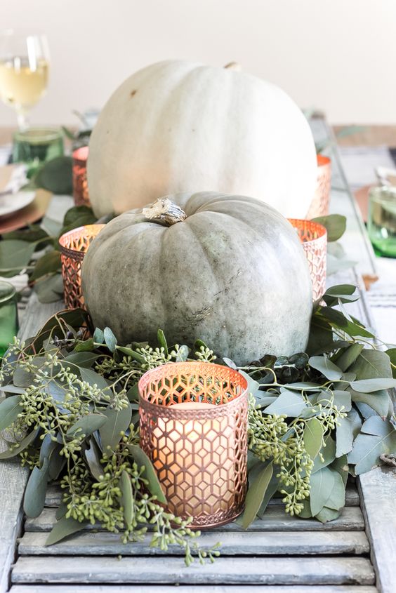 large heirloom pumpkins are amazing for decorating for the fall, add soem fresh eucalyptus and candles and a cool centerpiece is ready