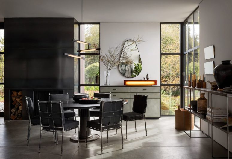 The dining space is done in black, with a unique mirror and a creative lamp