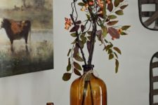 08 fresh branches with greenery and berries put into amber bottles will make nice fall decor